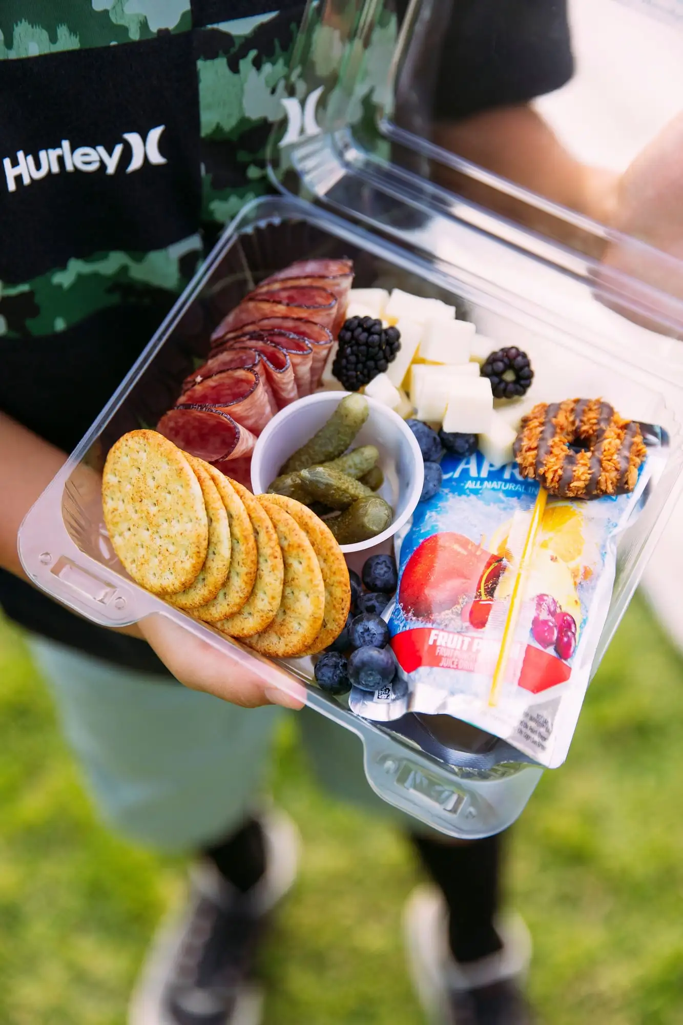Kids snack box with cubed cheese, salami, crackers, fruit and a juice pouch