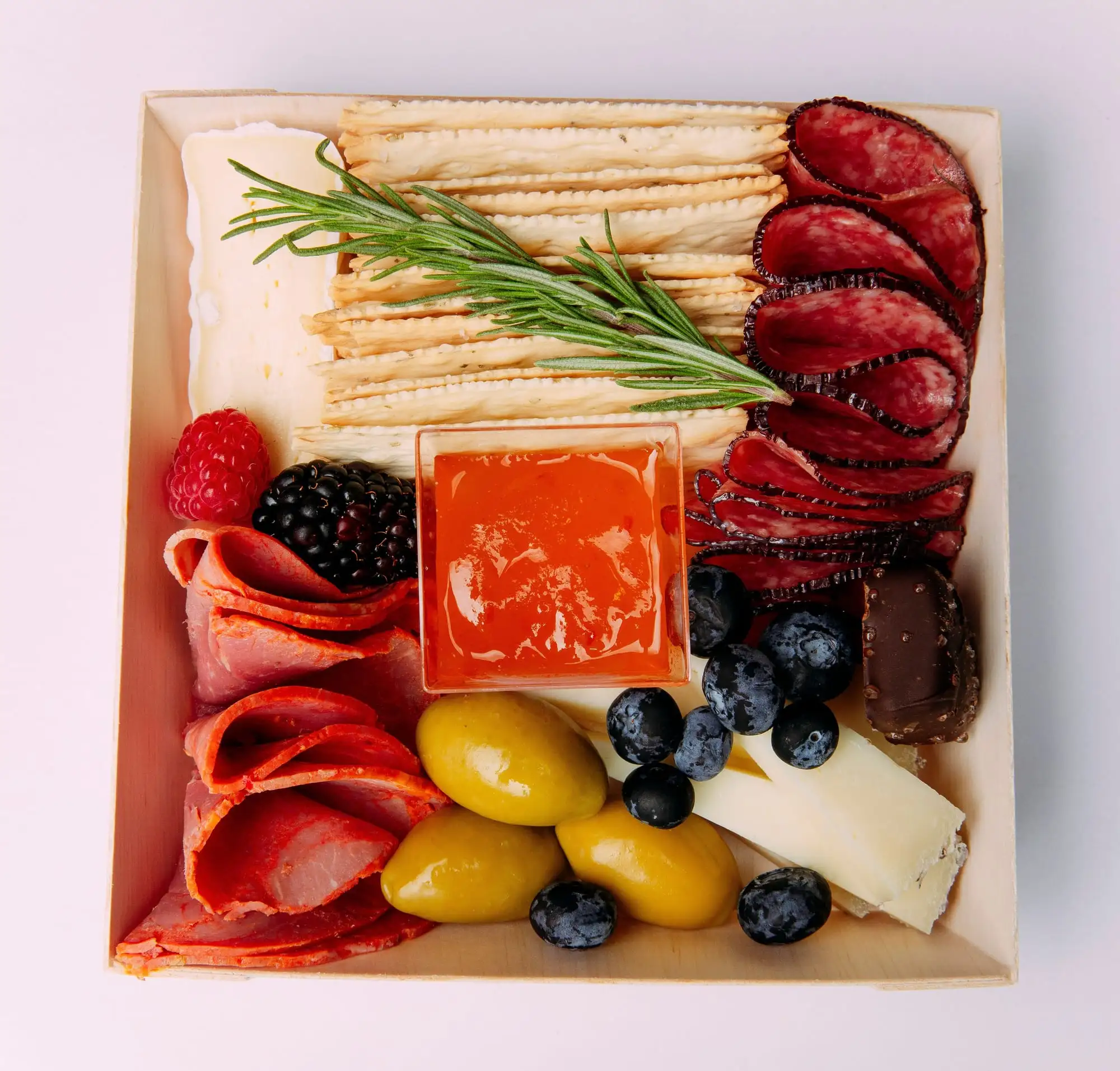 Individual charcuterie box with brie, salami, crackers, olives and fruit (view 5)