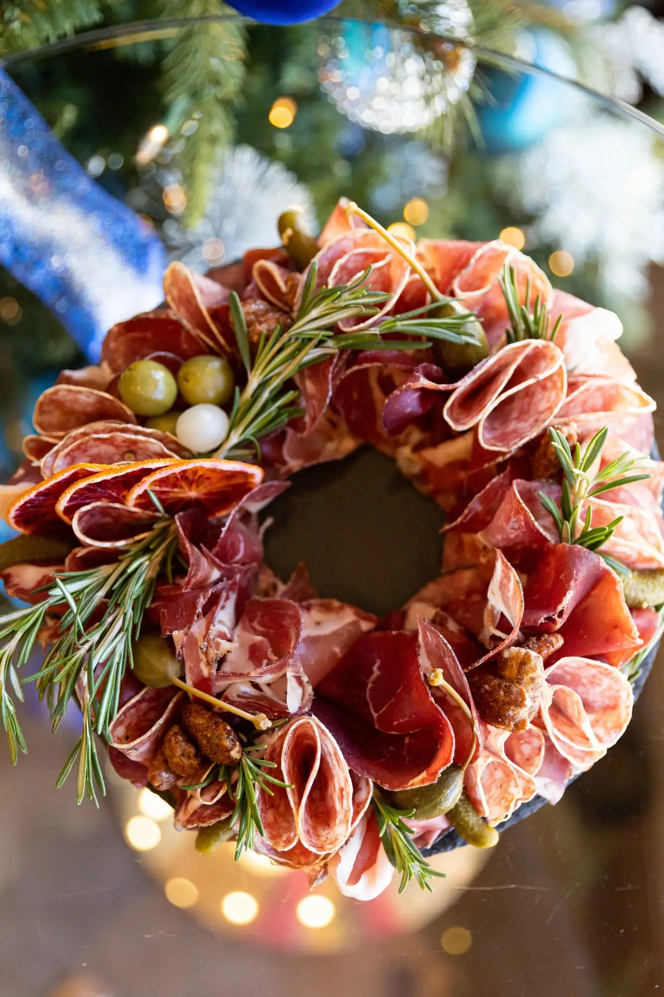 Round charcuterie wreath with cured meats, rosemary and cranberries